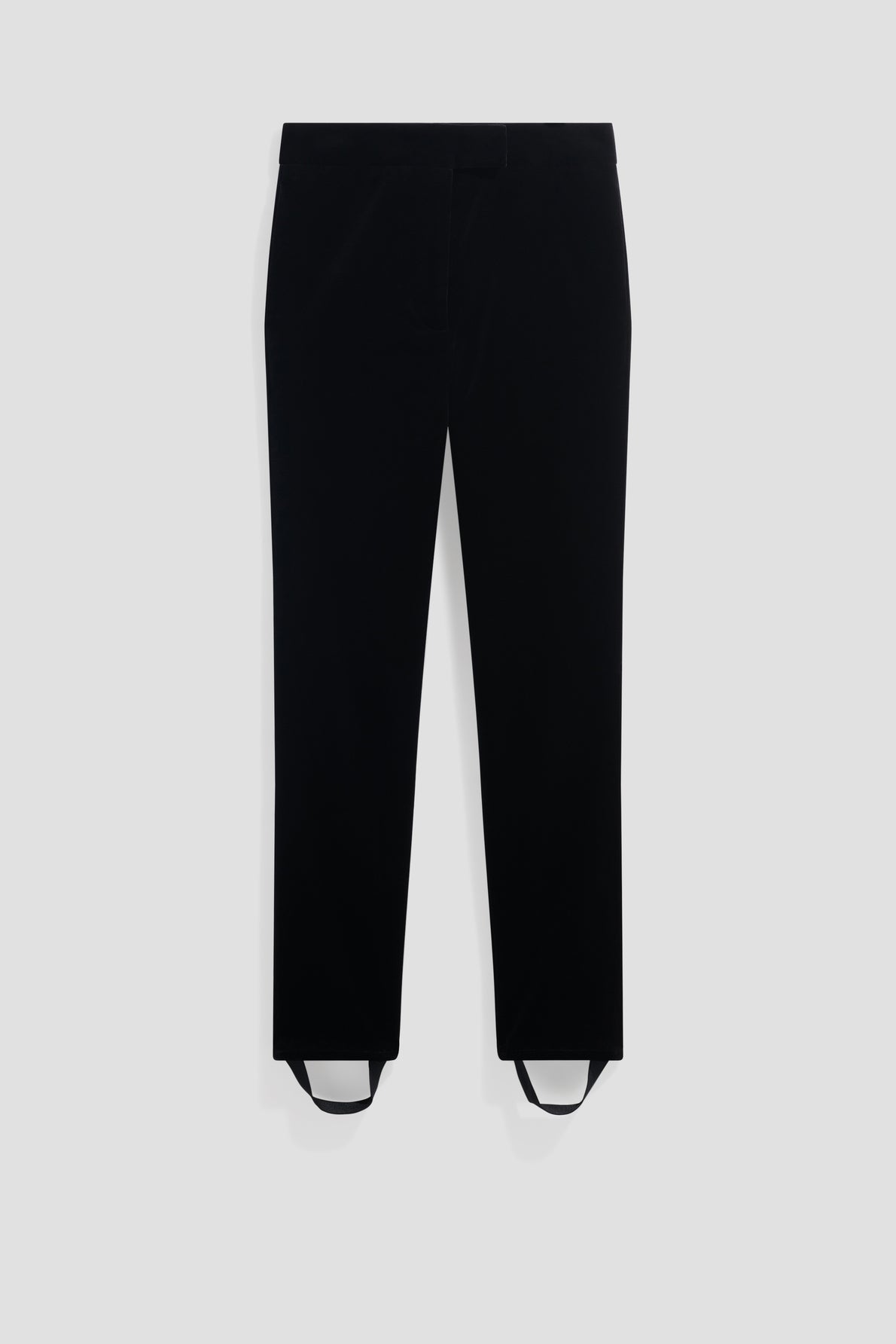 A pair of black pants with straight legs and stirrup straps at the cuffs, displayed against a plain light gray background.