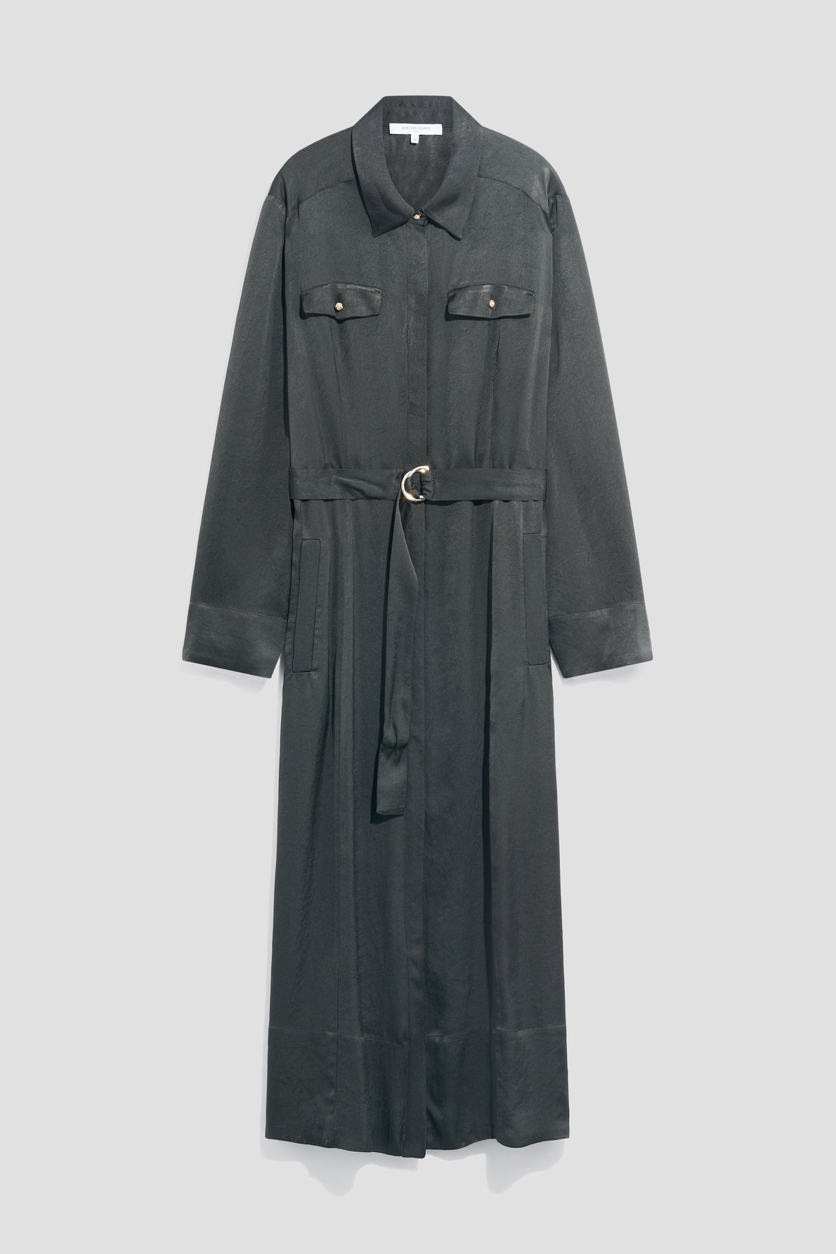 A long, dark green robe chemise satin shirt dress with long sleeves, two chest pockets, a collar, and a belted waist featuring a silver circular buckle, displayed against a plain light gray background.