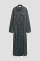 A long, dark green robe chemise satin shirt dress with long sleeves, two chest pockets, a collar, and a belted waist featuring a silver circular buckle, displayed against a plain light gray background.