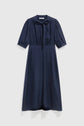 A navy blue, knee-length dress with short puff sleeves, a round neckline, and a subtle front tie detail. This robe élégante femme hangs gracefully against a plain, light-colored background.