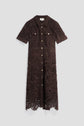 A brown robe midi en dentelle with short sleeves, front buttons, chest pockets, and a collared neckline is displayed against a plain light background. This robe cintrée combines elegant lace detailing with a flattering silhouette for timeless sophistication.