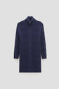 A navy blue, long-sleeve, cable-knit sweater in pure laine with a high col camionneur and a stylish half-zipper front, displayed on a plain light background.
