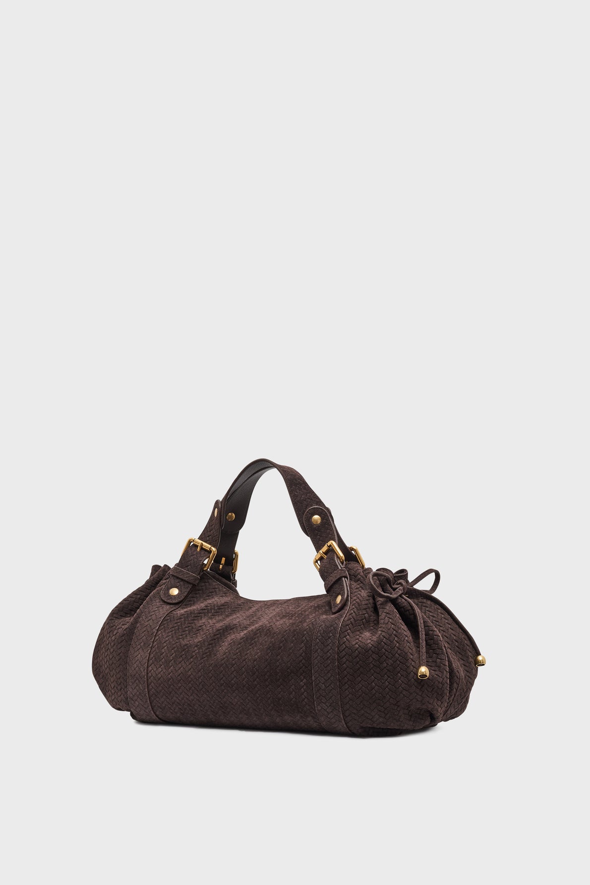 A dark brown textured sac à main with gold hardware, short handles, and side drawstring details, crafted from cuir velours tressé and set against a plain light background.