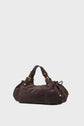 A dark brown textured sac à main with gold hardware, short handles, and side drawstring details, crafted from cuir velours tressé and set against a plain light background.