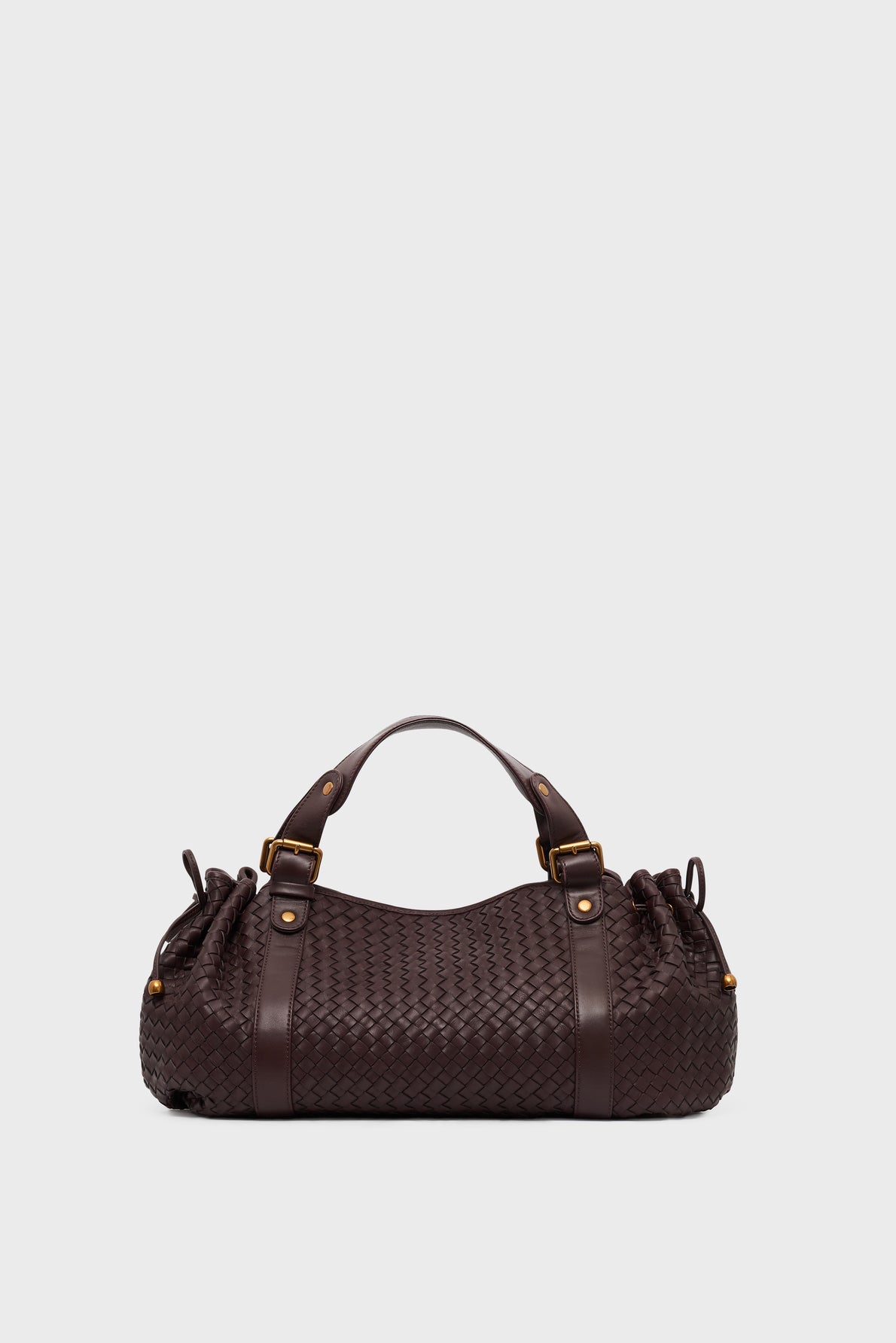 Dark brown cuir d’agneau tressé sac à main with two handles, gold hardware, and side detailing, displayed against a plain light gray background—a timeless 24H accessory.