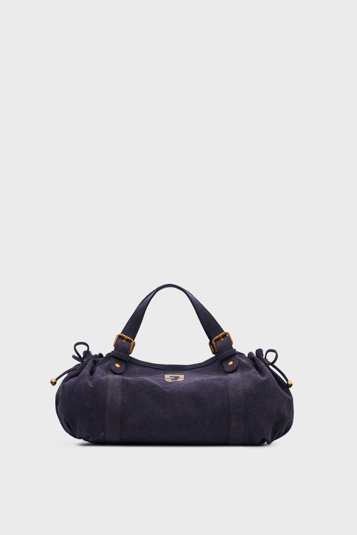 A dark navy suede sac à main with short handles, side bows, gold hardware, and a small metallic logo on the front. The bag is displayed against a plain white background.