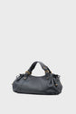 A black leather handbag with gold hardware, two handles, and gathered sides—reminiscent of the iconic sac 24H—is set against a plain light gray background, embodying the timeless elegance of maroquinerie Darel.
