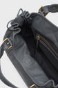 Dark gray leather handbag with gold hardware, an open main compartment, visible interior zip pocket, and a shoulder strap. Inspired by the iconic maroquinerie Darel style, this sac à main cuir features a black inside lining and a magnetic snap closure for effortless elegance.