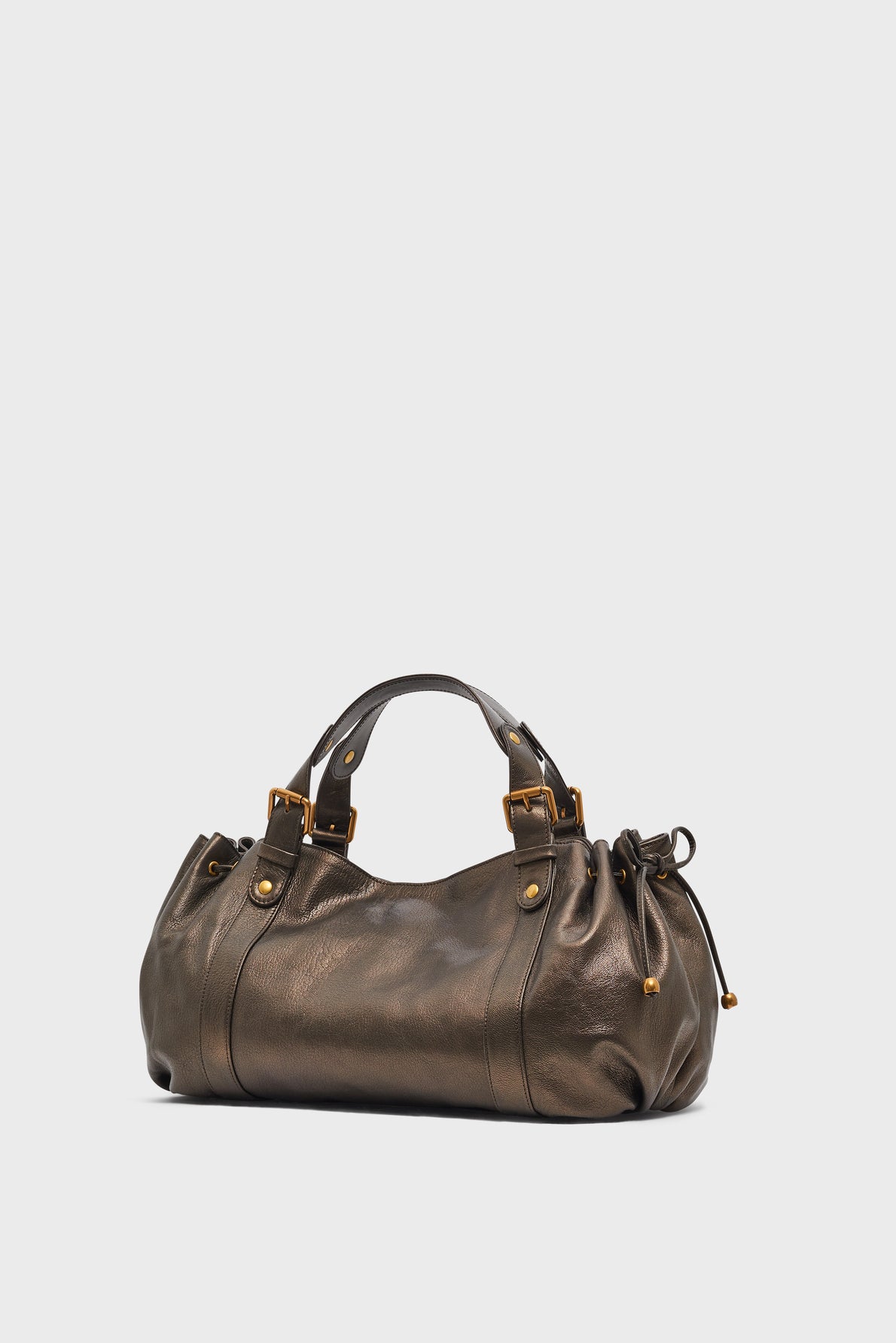 A metallic bronze leather sac à main with short handles, gold-tone hardware, and side drawstring details crafted from cuir de chèvre métallisé, set against a plain white background, exemplifying the elegance of maroquinerie Darel.