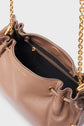 A close-up of a taupe cuir grainé leather sac bandoulière with gold chain straps, a ruffled top edge, and an open zipper revealing a black fabric interior. The brand GERARD DAREL is stamped in gold on the outside.