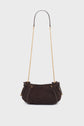 Dark brown textured mini 24H handbag with a gold chain shoulder strap. Crafted from luxurious cuir velours tressé, the bag has a rounded shape, drawstring sides, and is displayed on a plain, light background.