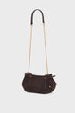 Dark brown textured sac bandoulière with a long gold chain strap and leather shoulder piece. Crafted from cuir velours tressé, this handbag features a rounded shape, gold accents, and a drawstring closure with decorative knots and small gold beads. The background is plain white.