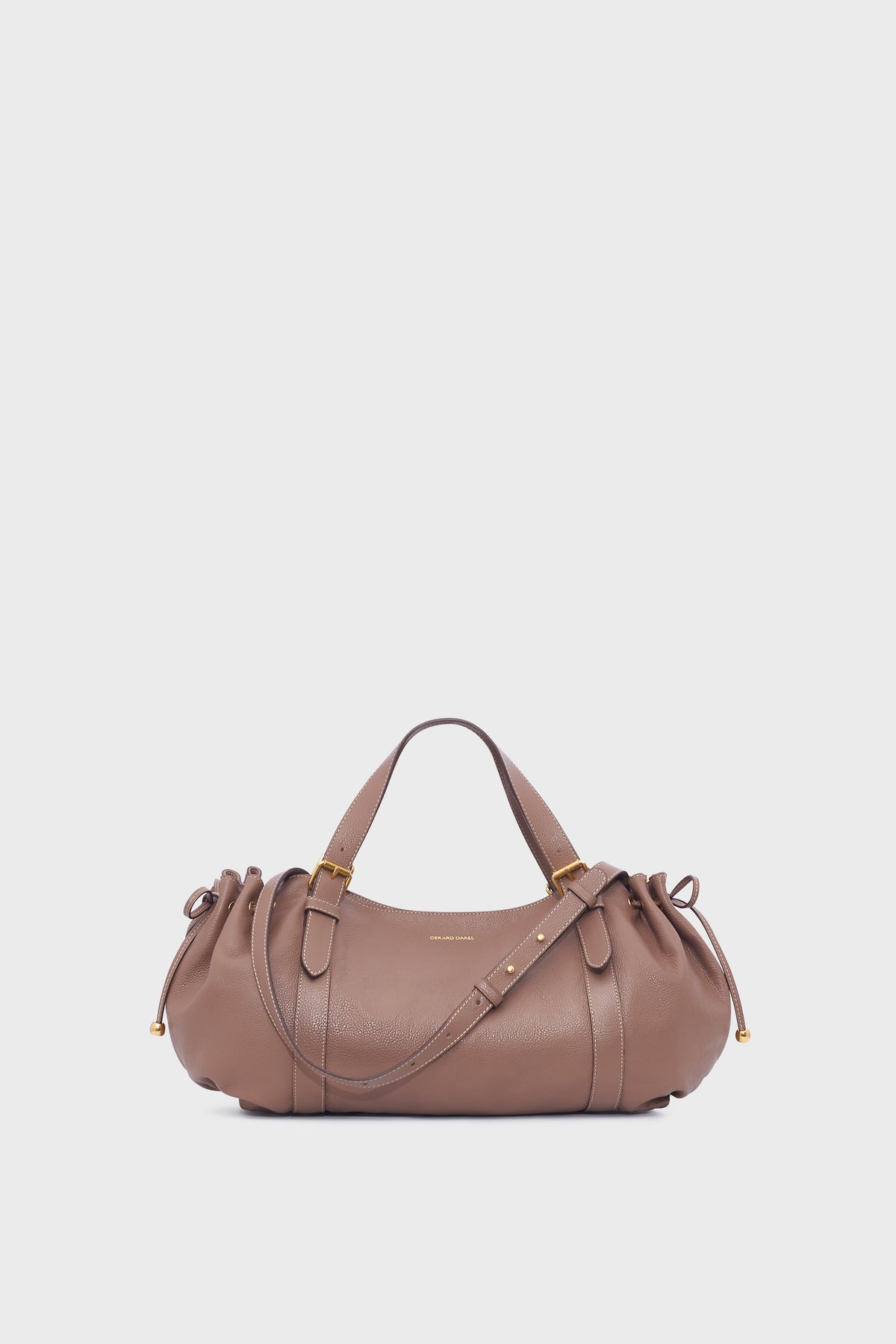 Taupe cuir grainé sac à main by Gerard Darel, featuring gold hardware, short handles, and drawstring sides, displayed on a plain white background.