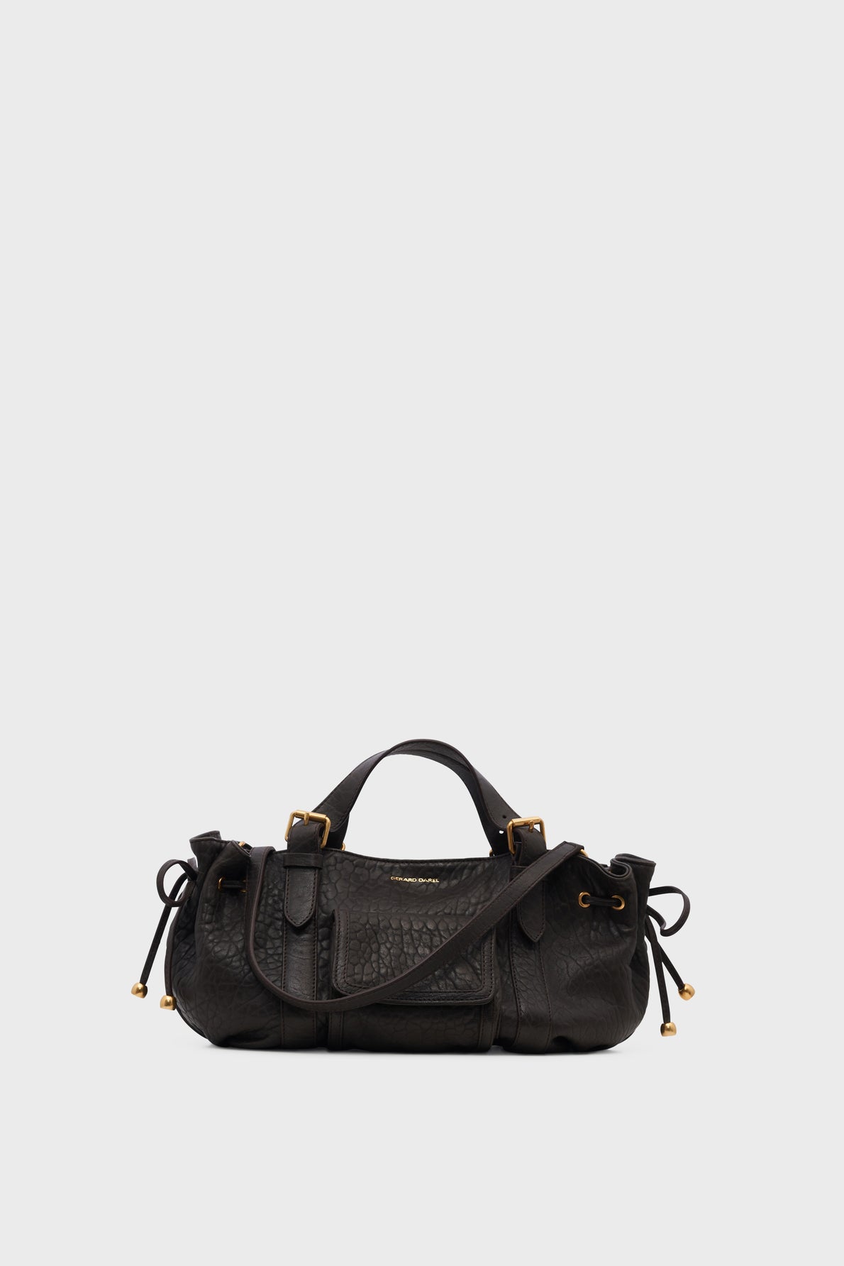 A black sac à main in cuir bubble with gold hardware, short handles, and adjustable side ties, displayed against a plain light grey background.