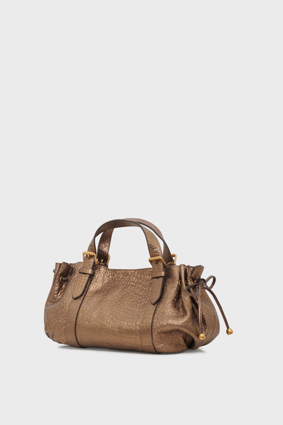 Bronze textured leather sac à main with two handles, gold accents, and decorative side drawstrings in cuir mouton bubble, placed against a plain light background.