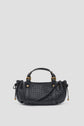 A black sac à main tressé in woven cuir d’agneau leather, featuring two handles, gold hardware, and side drawstring details, displayed against a plain light gray background.
