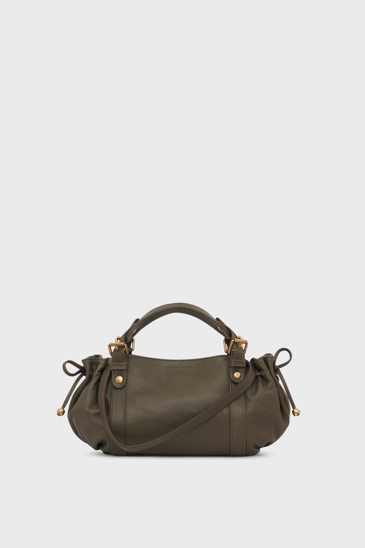 Olive green sac à main en cuir with gold hardware, two handles, and gathered sides tied with strings. This handbag features a bandoulière amovible for versatile carrying options, along with a rounded, soft structure and minimal design against a plain white background.