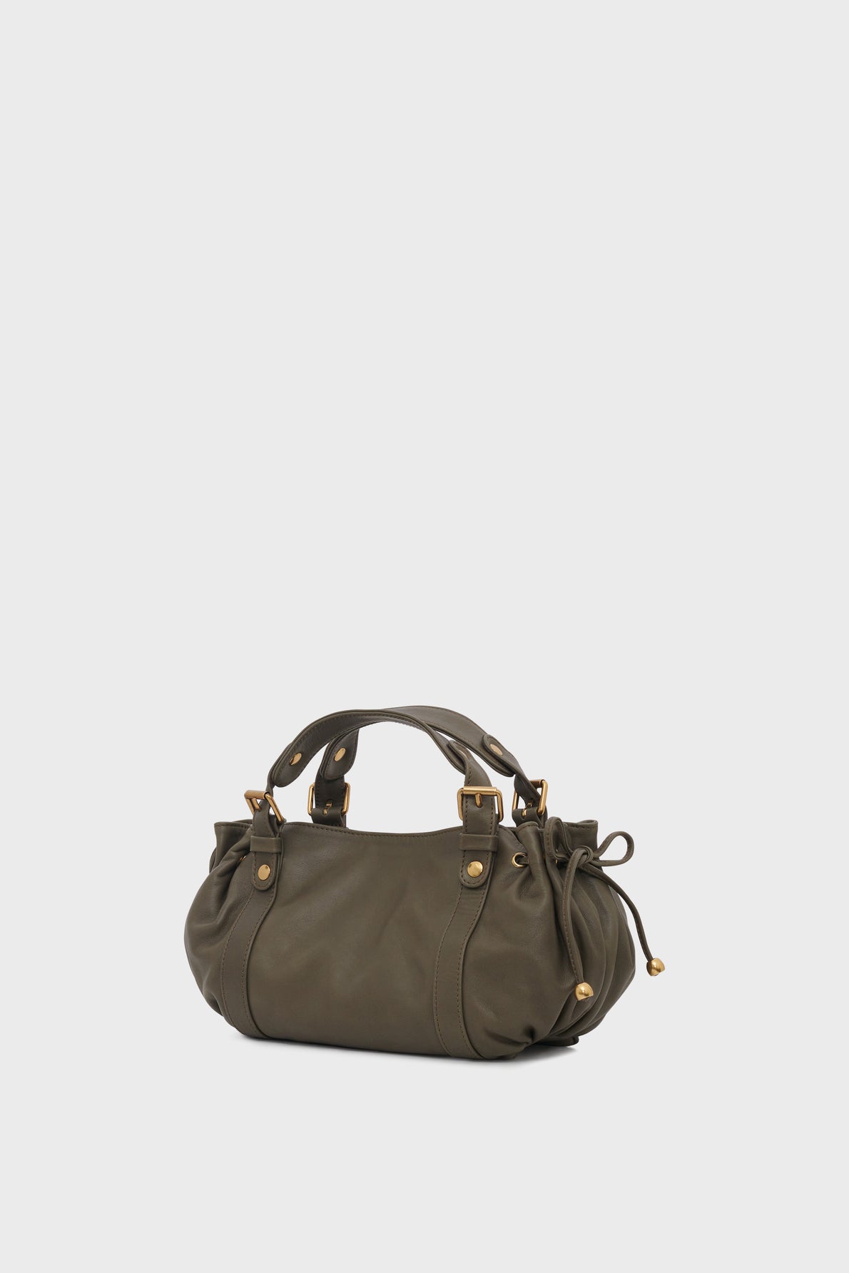 A small, olive-green sac à main in cuir with gold hardware, two short handles, a bandoulière amovible, and drawstring details on the sides, set against a plain light gray background.