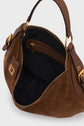 A brown cuir velours suede handbag with gold hardware, unzipped to show a black fabric interior and an inner zip pocket. The sac hobo features leather handles and decorative buckles on each side, perfect for adding a touch of chic parisienne flair to any ensemble.