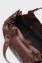Open brown leather sac à main cuir with gold hardware, showing a black fabric-lined interior and a zippered pocket. This élégant français bag features a flap with a snap closure and visible stitching details, embodying the refined style of the sac CHIARA GD.
