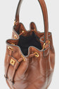 A brown leather bucket bag (sac seau cuir) with gold hardware, quilted pattern, drawstring closure, and a top handle. The bag is open, showing the dark interior—a chic sac bandoulière femme ideal for effortless style.