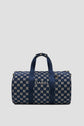 A navy blue sac de sport duffel bag with a geometric white pattern, two handles, and the word DAREL printed in white on the front.