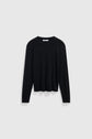 A plain black long-sleeve crew neck sweater, crafted from coton épais for extra warmth, is displayed on a light gray background.