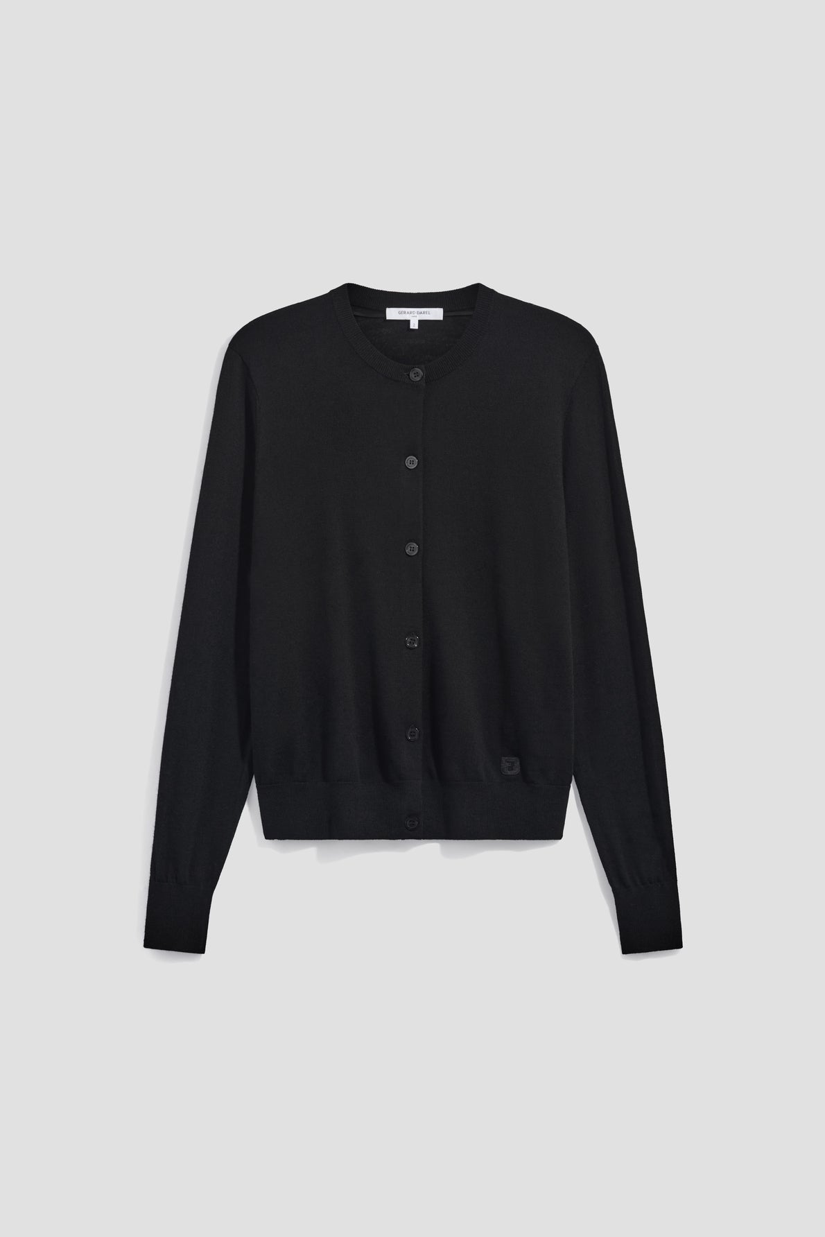 A black, long-sleeve, button-up cardigan en laine mérinos is displayed against a plain light gray background, showcasing the timeless elegance of a gilet femme.