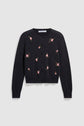 A black long-sleeve gilet boutonné with pink and green motif fleuri embroidery scattered across the front, buttoned down the center.