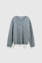 Light blue, long-sleeve, fuzzy knit sweater with a crew neckline, ribbed cuffs, and ribbed hem displayed against a plain white background. This pull bleu grisé features a cachemire brossé texture, making it an ultra soft and comfortable pull ultra doux for everyday wear.