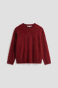 A long-sleeved, fuzzy pull rouge sweater with a crew neckline and ribbed cuffs and hem, displayed on a plain light gray background.