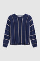 A pull bleu jean long-sleeve sweater in navy blue, featuring elegant white and beige vertical and horizontal stripes, laid flat on a white background.