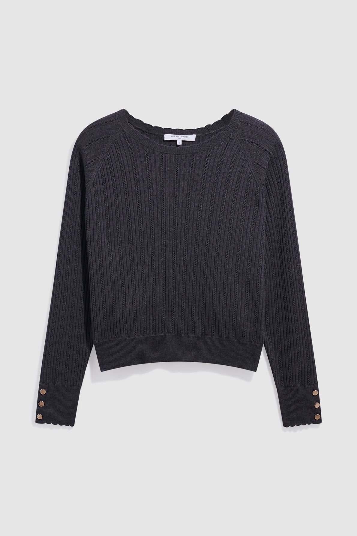 A black long-sleeve maille à côtes sweater with scalloped edges at the cuffs and neckline, featuring three decorative buttons on each cuff, displayed on a white background.
