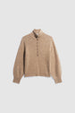 Beige knit pull à col montant sweater with a high collar, buttoned half-placket featuring boutons argentés, ribbed cuffs, and waistband. The laine camel chinée fabric appears soft and textured, with subtle flecks throughout. Sweater is laid flat on a light background.