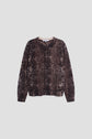 Long-sleeved button-up shirt with an imprimé python, laid flat on a light gray background.
