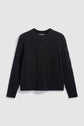 A black, long-sleeve cable knit sweater with a round neckline, featuring classic esprit irlandais diamond and braided torsades patterns, laid flat on a light gray background.