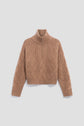 A brown cable-knit sweater in soft laine with a col montant zippé and half-zip front, featuring diamond and braided patterns on the body and sleeves, laid flat on a light background. This timeless pull camionneur blends classic style with cozy comfort.