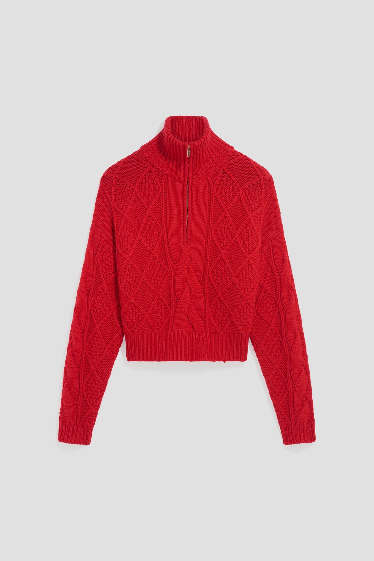 A bright red pull camionneur laine, cable-knit sweater with a col montant zippé and a half-zip front, featuring intricate maille torsadée with diamond and braided patterns.