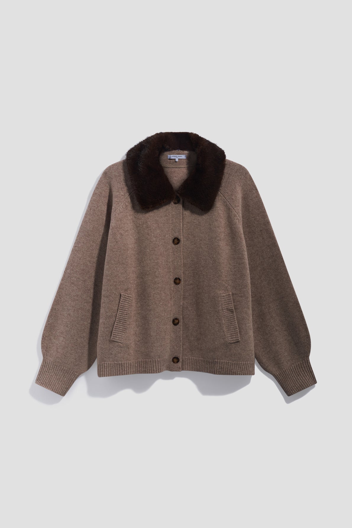 Brown button-up cardigan with a dark brown fausse fourrure collar, two front pockets, and ribbed cuffs and hem, displayed against a light gray background.