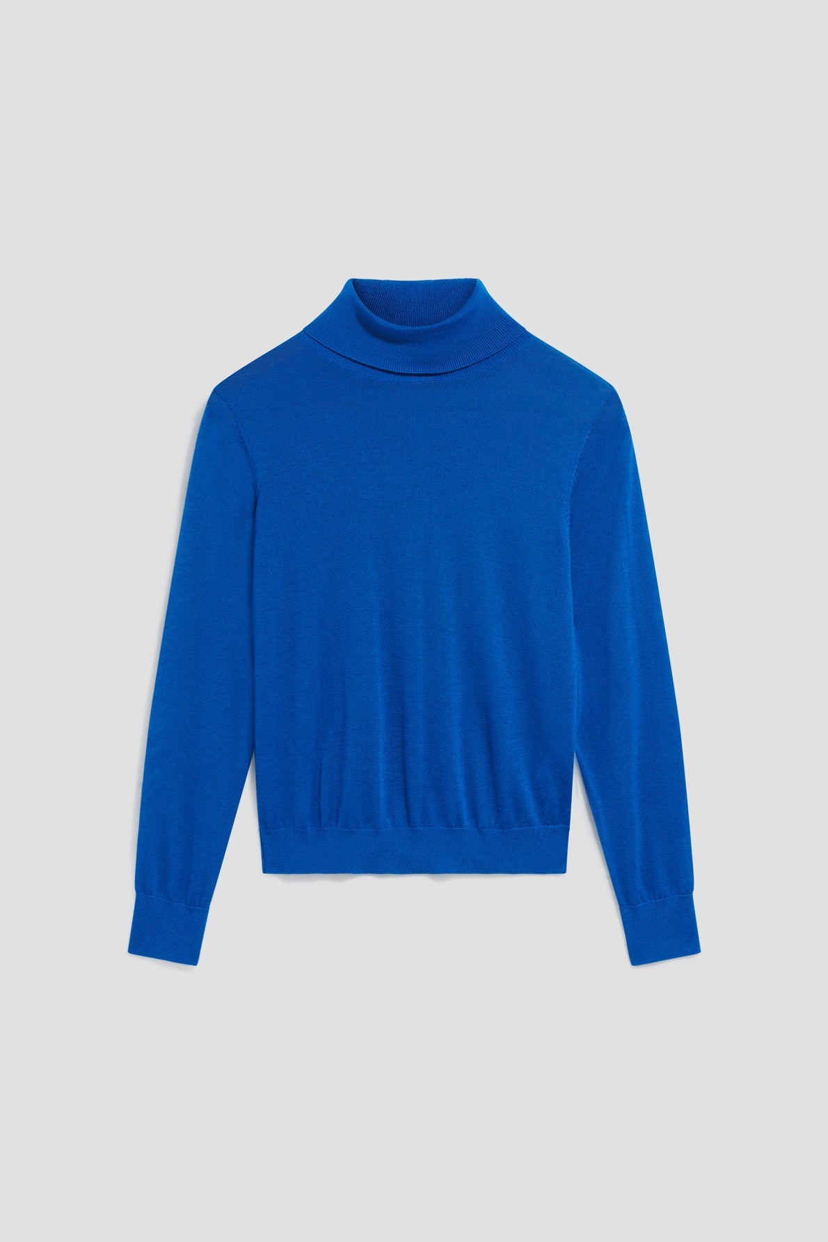 A bright blue long-sleeve pull col roulé sweater is laid flat on a light gray background. Crafted from soft laine mérinos, the sweater features a fitted collar, ribbed cuffs, and a ribbed hem.
