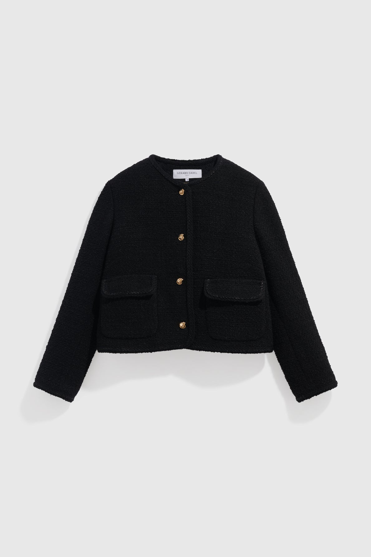 Black, long-sleeved, collarless veste courte noire with boutons dorés and two front flap pockets, displayed on a plain white background.
