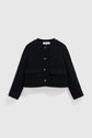 Black, long-sleeved, collarless veste courte noire with boutons dorés and two front flap pockets, displayed on a plain white background.