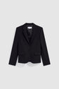 A black tailored blazer with notch lapels, two front buttons, flap pockets, and a chest pocket is displayed against a plain light gray background. This veste noire de tailleur exudes a chic sophistication, perfect for elevating any ensemble.