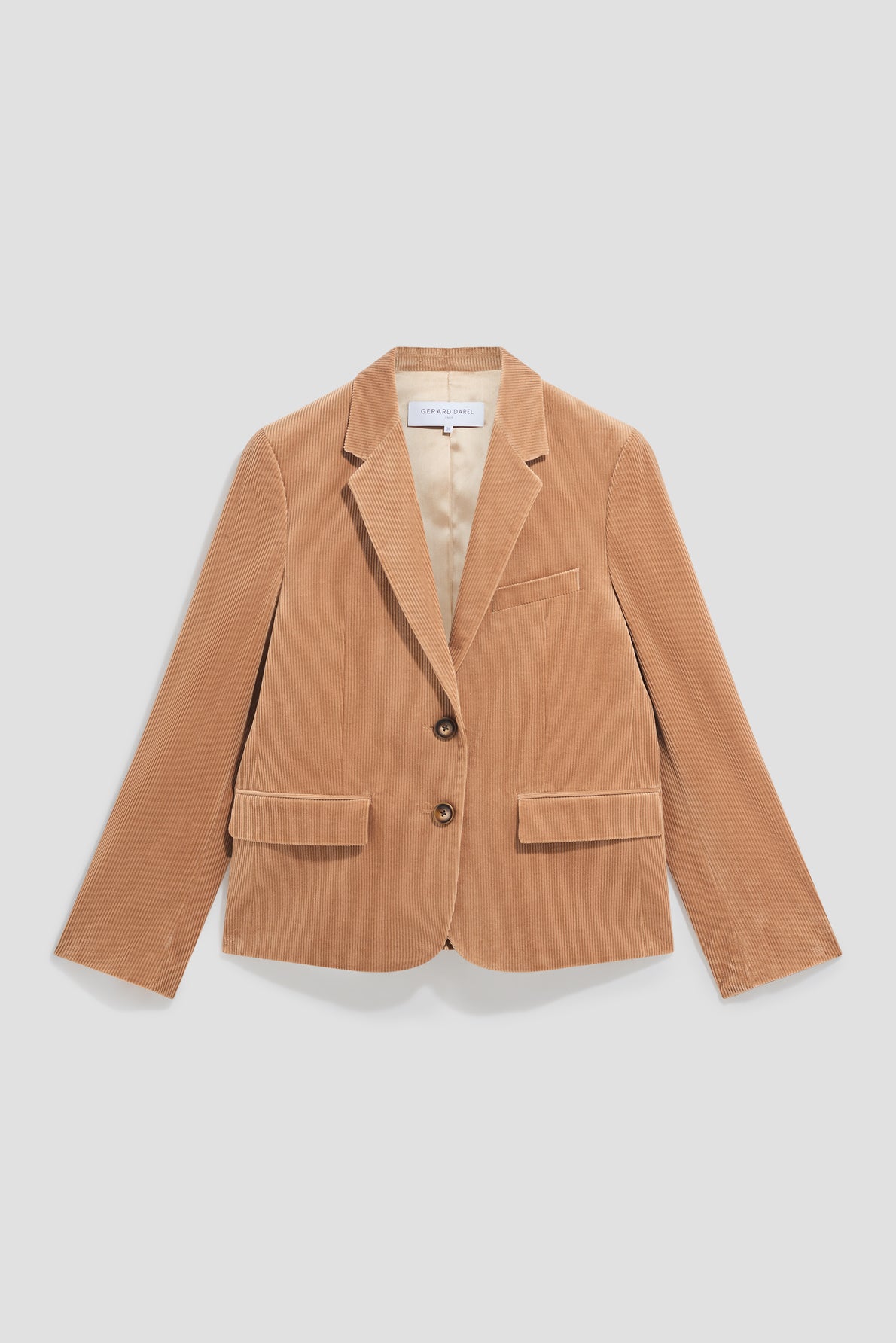 Tan corduroy blazer with two buttons, a notched lapel, one chest pocket, and two front flap pockets, laid flat on a white background—this veste tailleur velours is the perfect blend of chic and décontractée style for any occasion.