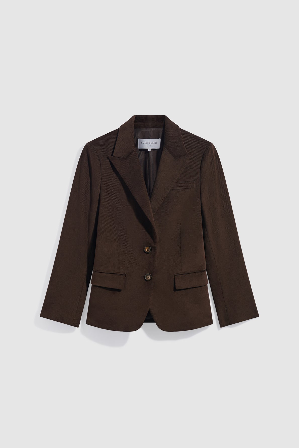 A dark brown veste mi-longue tailored blazer with two buttons, notched lapels, and two front flap pockets, displayed on a light gray background.