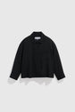A black, long-sleeve, button-up surchemise noire with a collar and a single chest pocket, displayed against a plain white background—a perfect blend of workwear utility and chemise chic style.