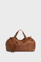 A brown cuir doux leather duffel bag with gold hardware, dual handles, side drawstring details, and a zippered top is set against a plain light background—a stylish sac à main designed for 72h getaways.