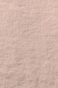 Close-up of light brown, textured fabric with visible weave and subtle creases throughout the surface.