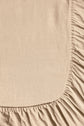 Close-up of beige fabric with a gathered, ruched edge forming a curved seam, possibly part of a sheet or garment. The texture appears soft and slightly wrinkled.