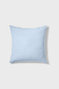 A square, light blue pillow on a plain white background, casting a soft shadow to the right.